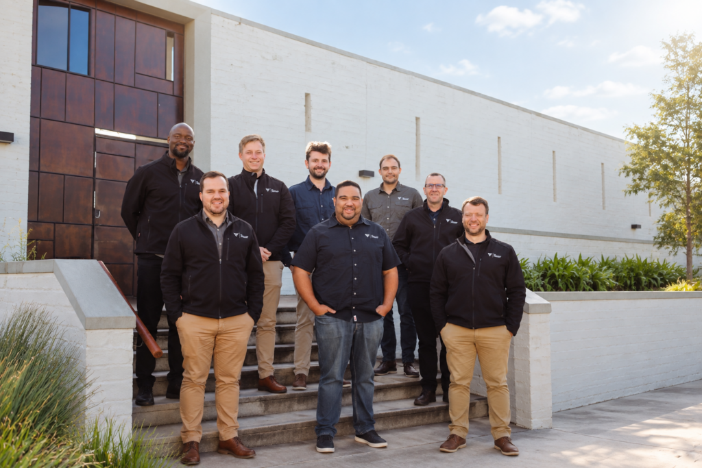 FHI Consulting Engineers team on the steps outside a building